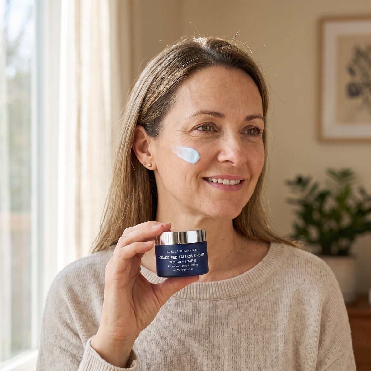 Woman holding the Avella Organics tallow cream